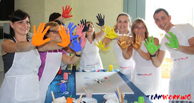 Hands and brushes at work on a canvas during an Action Painting activity