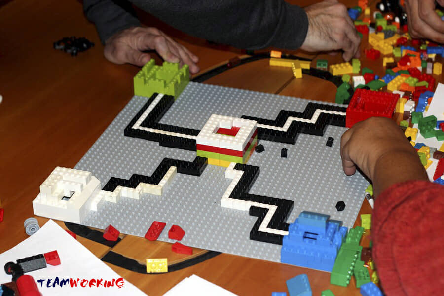 A team building a three-dimensional model out of Lego bricks