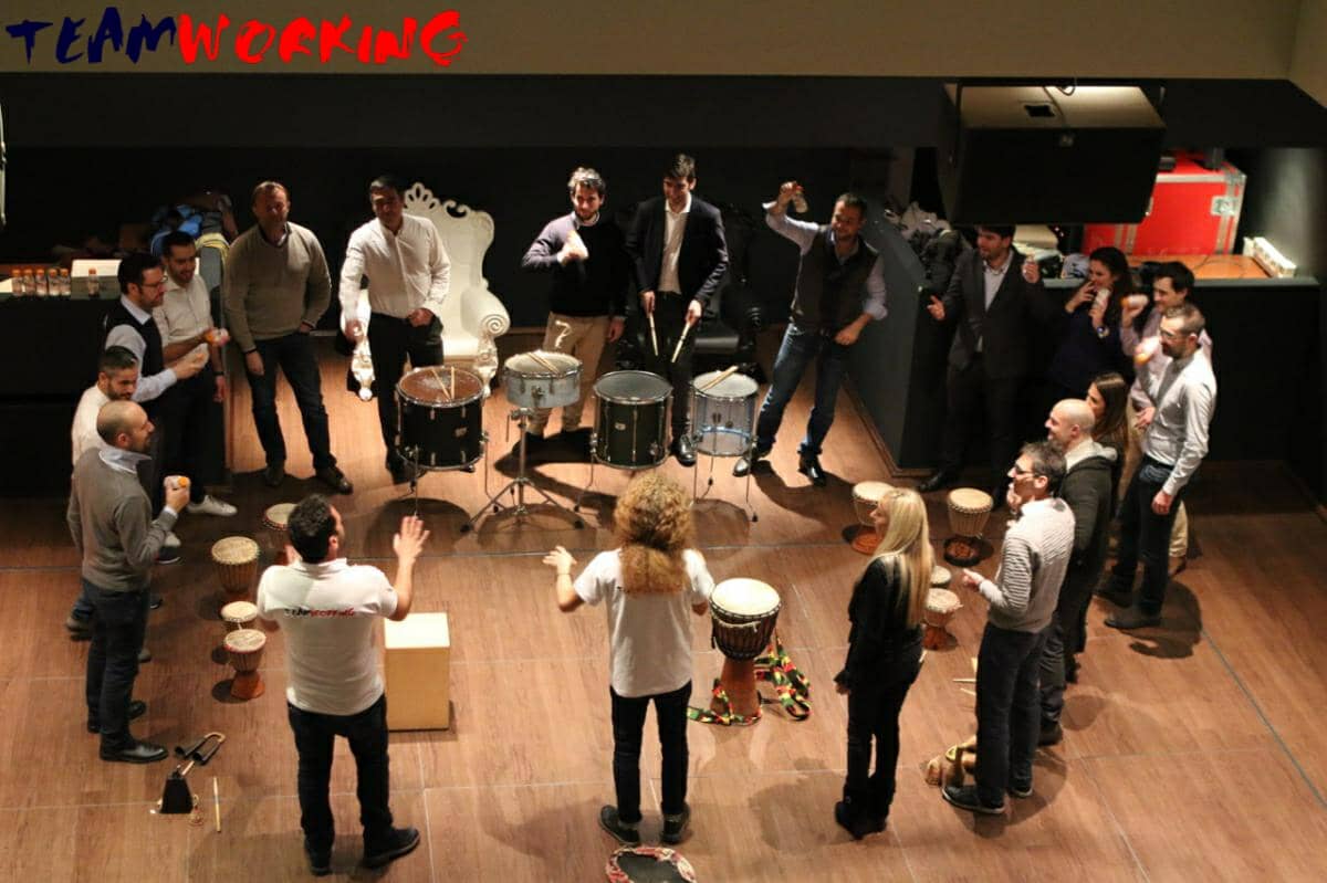 A group playing percussion together in a circle