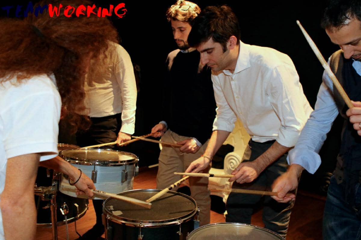 A group playing percussion together in a circle