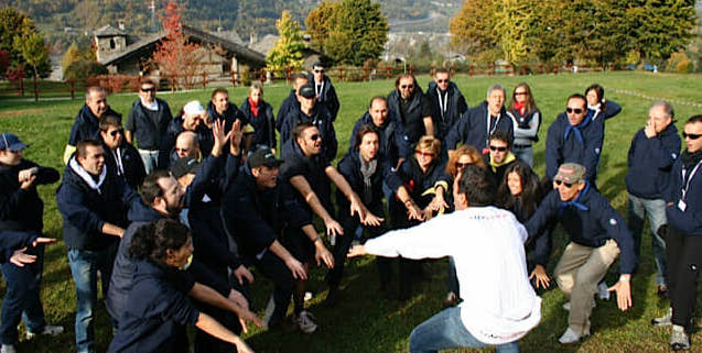 A team working through an outdoor exercise in the open air