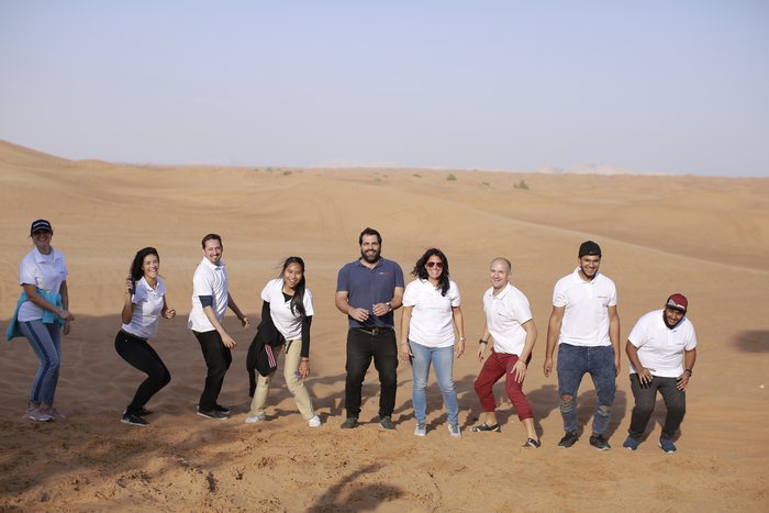 A team out in the desert of the Emirates at the end of the day