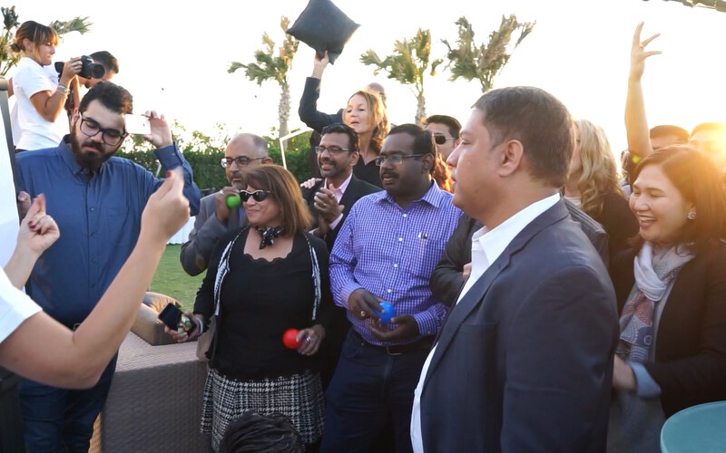 A large group outdoors during a big event in the Gulf, at sunset