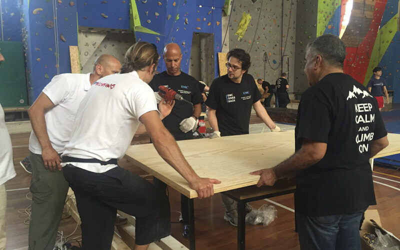 Trainers and participants building together at the climbing wall