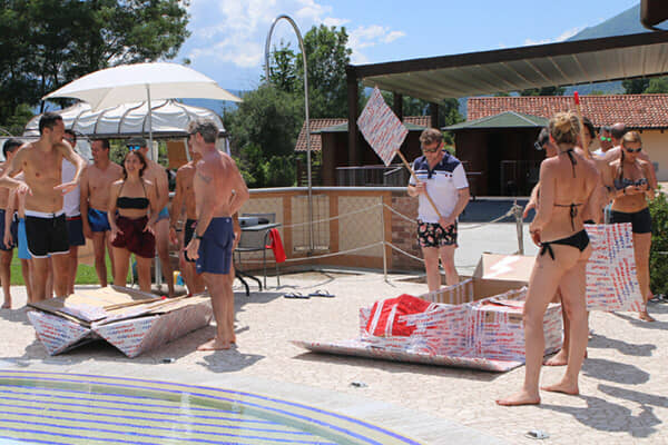 A cardboard boat built by a team, at the water for the final test