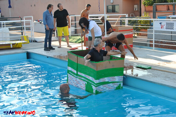 A cardboard boat built by a team, at the water for the final test