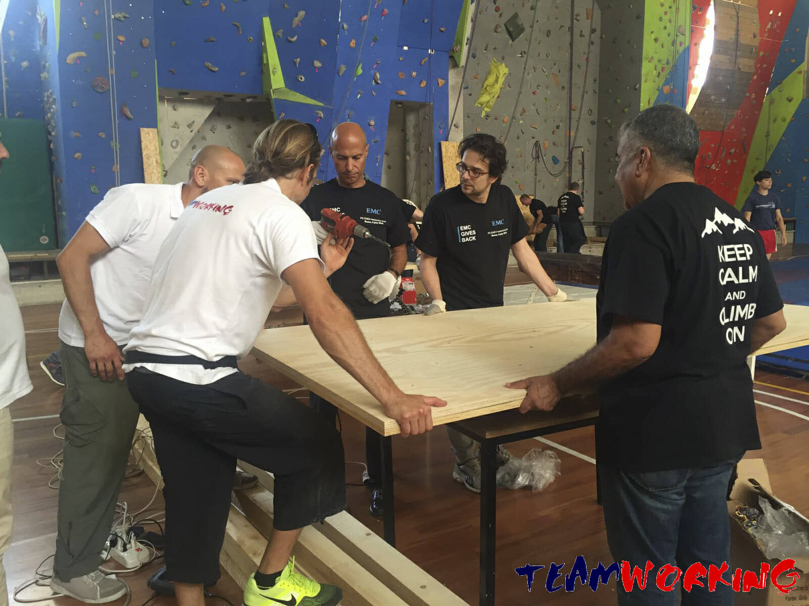 A team building something with real tools for a school or a community