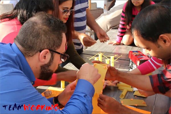 A team building a structure with limited materials