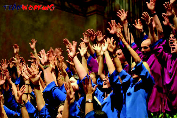 A corporate choir singing together with a choirmaster