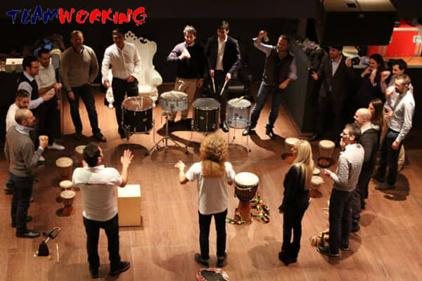 A group playing percussion together in a circle