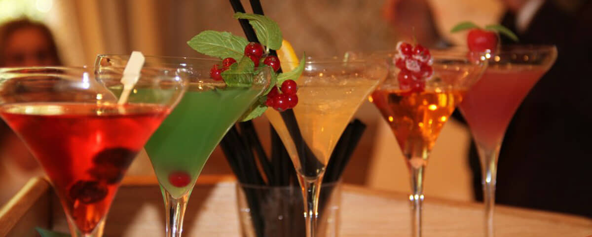 A team mixing cocktails with professional bartenders