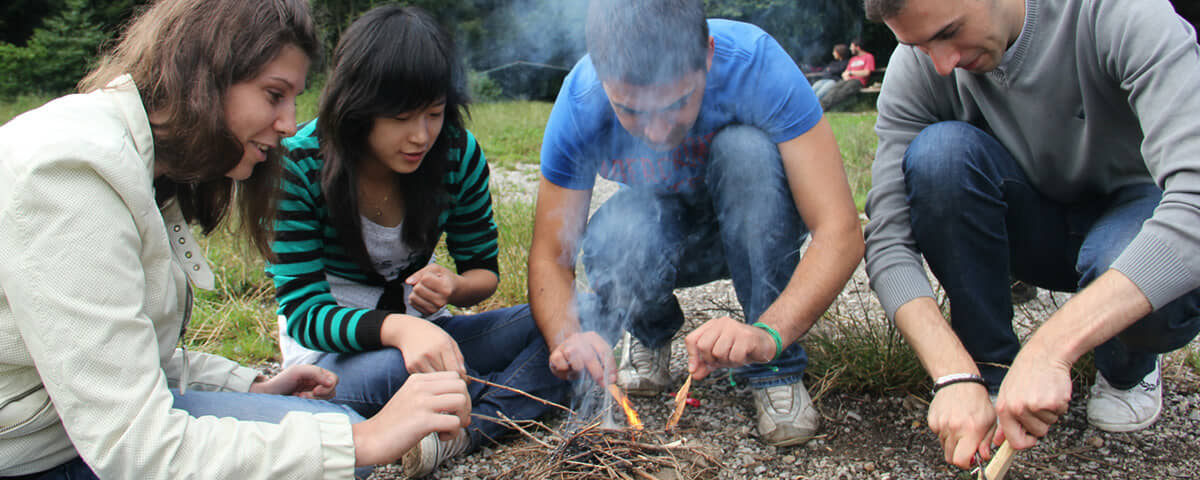 A team working through an outdoor exercise in the open air