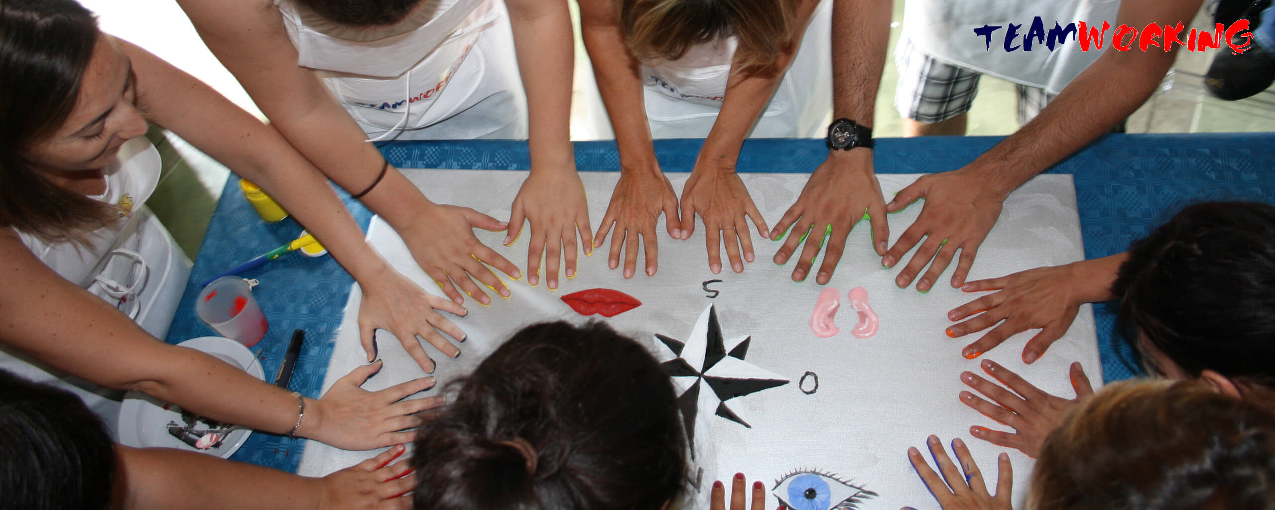 Hands and brushes at work on a canvas during an Action Painting activity