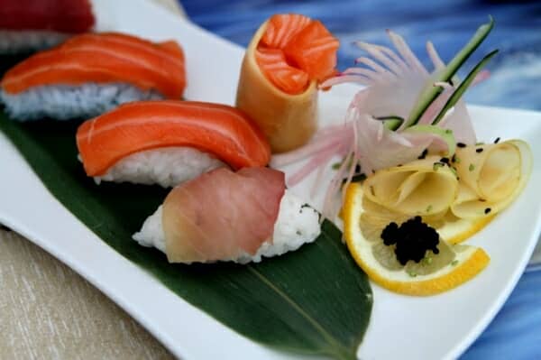 Participants preparing sushi under the guidance of a sushi master